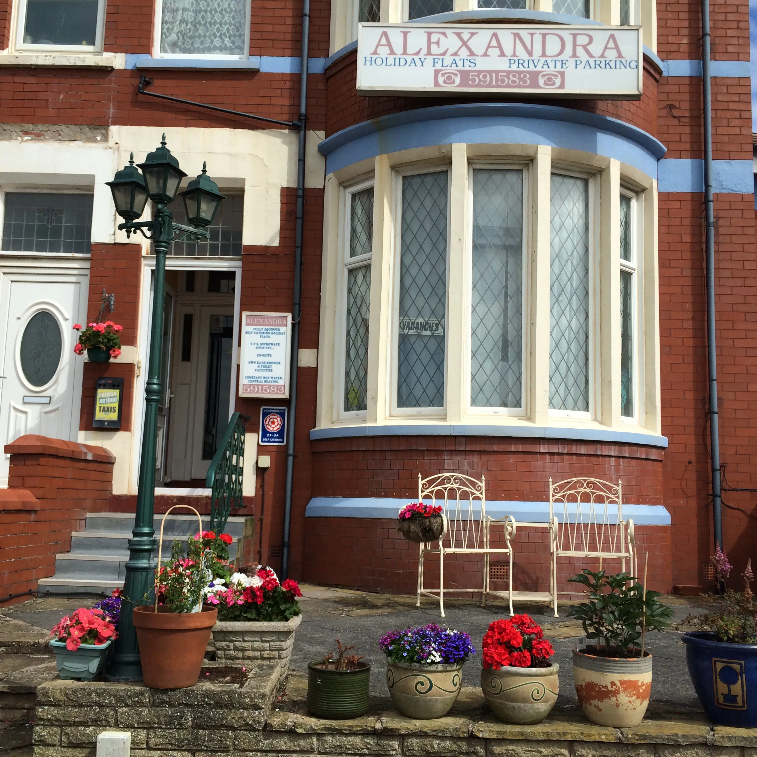 Alexandra Holiday Flats entrance, front window and flower pots